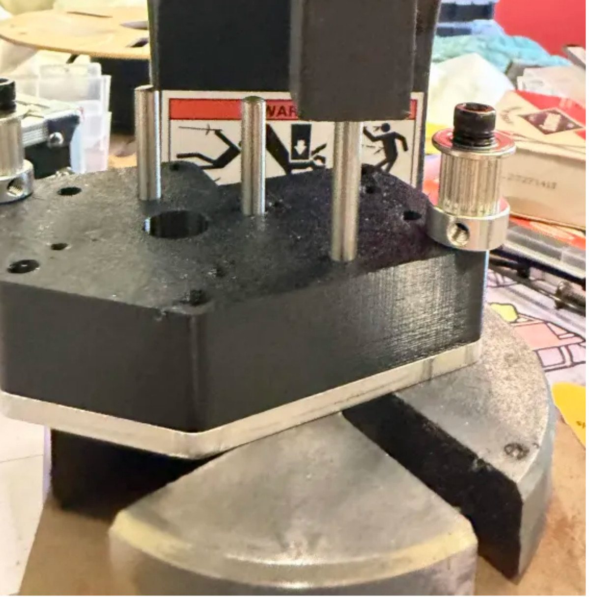 An arbor press seating dowel pins through a jig