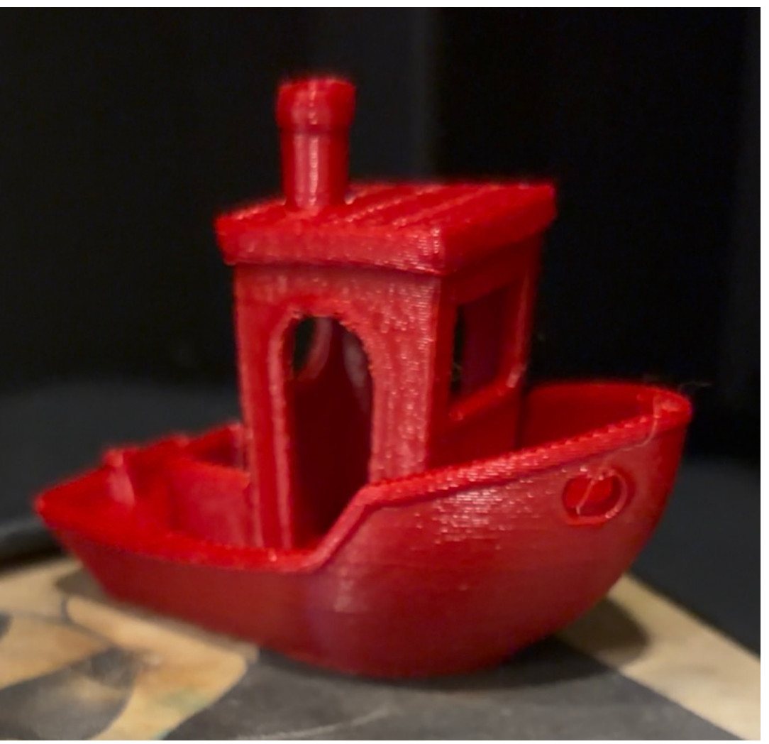 A red 3DBenchy boat printed on Boaz