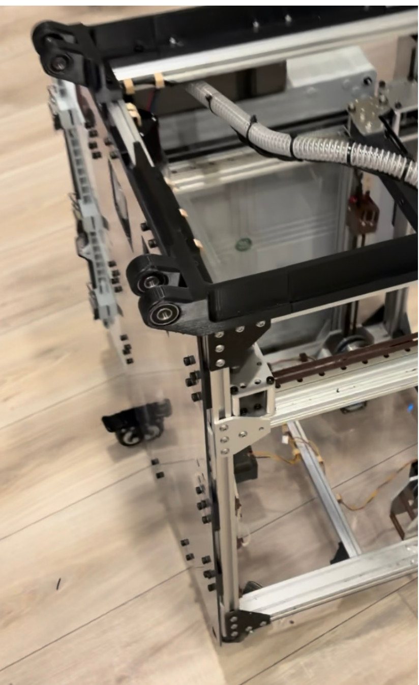The finished Boaz printer: a two-tier aluminum extrusion frame with gusset plates and a polycarbonate enclosure on top.