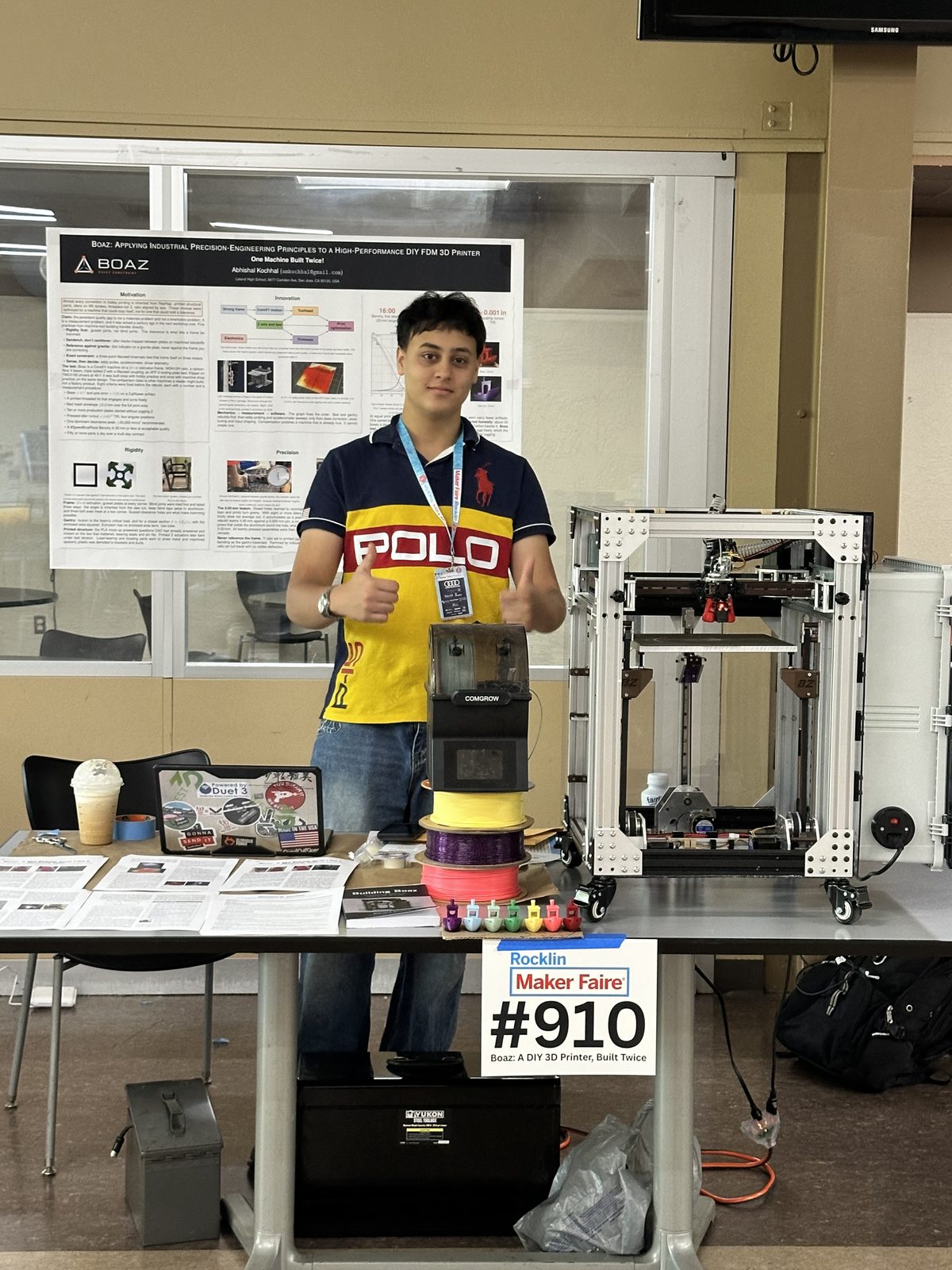 Me at my Maker Faire booth beside the Boaz printer, with the poster behind me