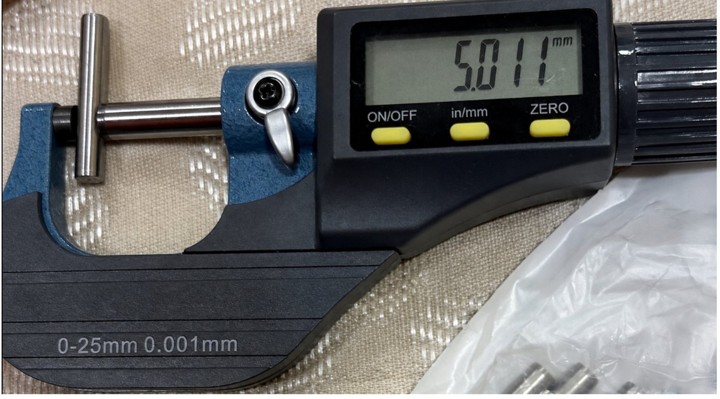 A micrometer measuring a dowel pin