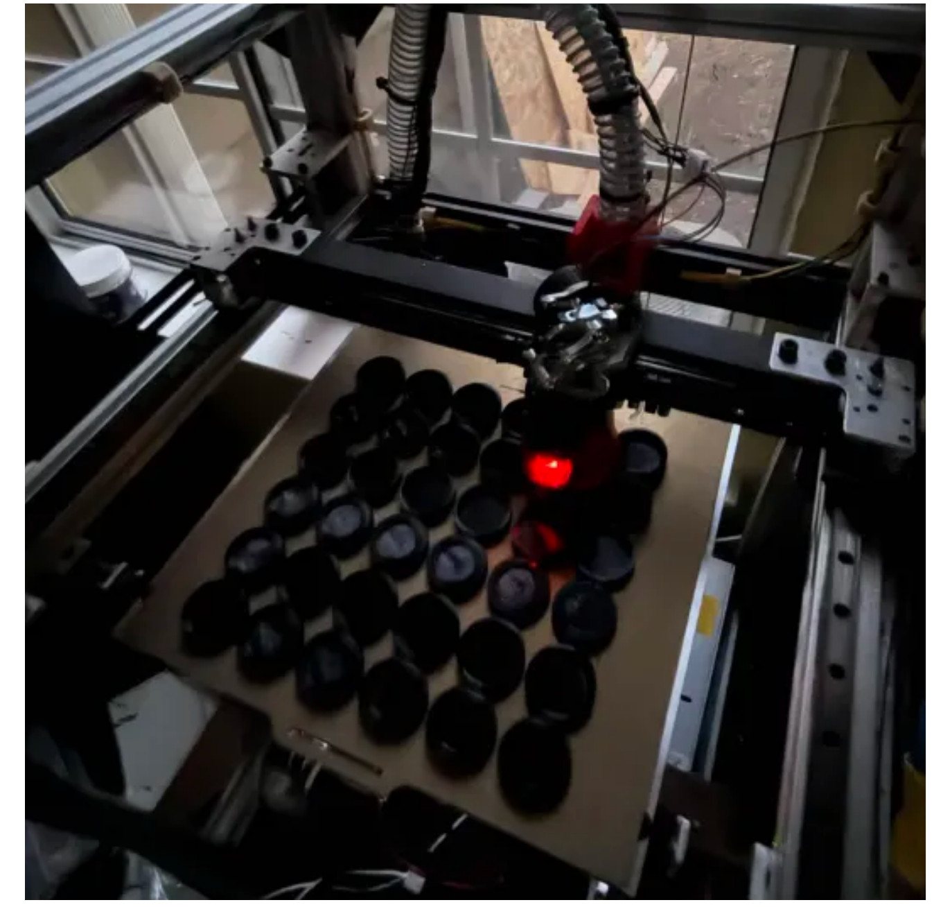 A print bed full of black PETG boxes